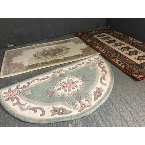 11 - Two small Chinese style rugs together with a red Oriental rug