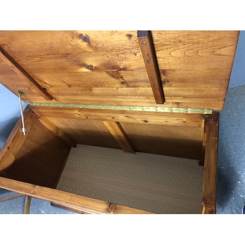 14 - A stained pine blanket box together with a stained pine occasional table