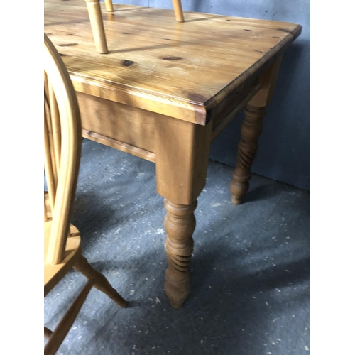 16 - A pine kitchen table together with three pine wheelback chairs 121x75x77