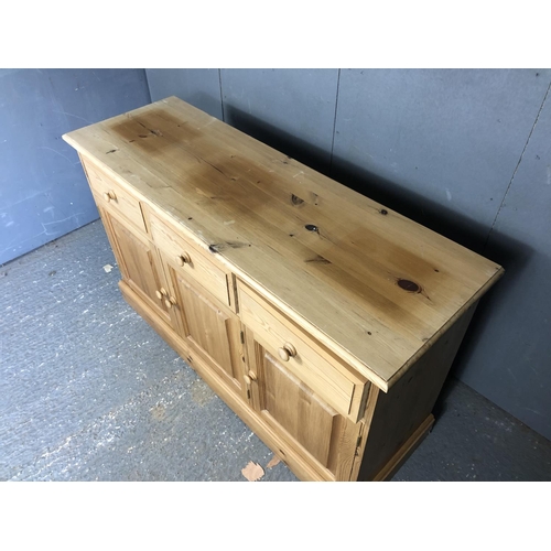 19 - A solid pine three drawer sideboard 131x43x80