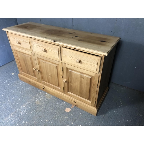 19 - A solid pine three drawer sideboard 131x43x80