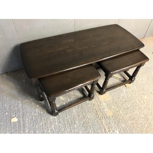 28 - A dark Ercol nest of three tables 114x50x42