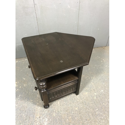 29 - A dark Ercol drop leaf corner occasional table with a single drawer