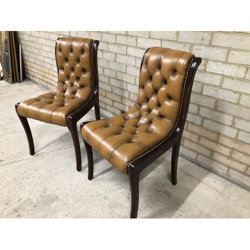 53 - A pair of brown leather Chesterfield side chairs