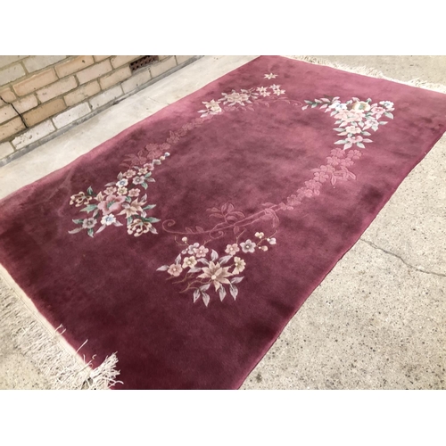 56 - A large pink Chinese style carpet 130x207