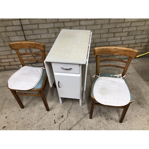 61 - A vintage painted drop leaf table together with two kitchen chairs