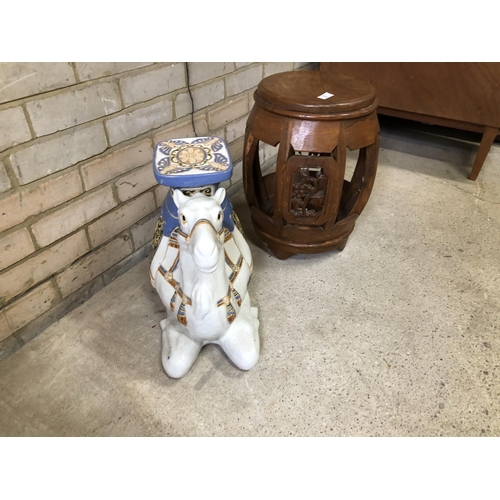 80 - A hardwood Oriental stool together with a ceramic camel stool