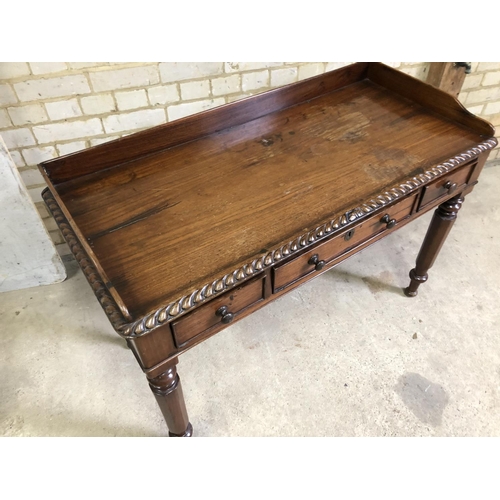 93 - A  Victorian rosewood three drawer writing table with a gallery back 116x52x73