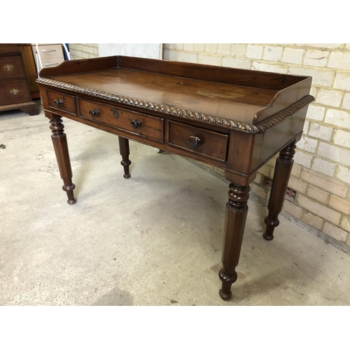 93 - A  Victorian rosewood three drawer writing table with a gallery back 116x52x73