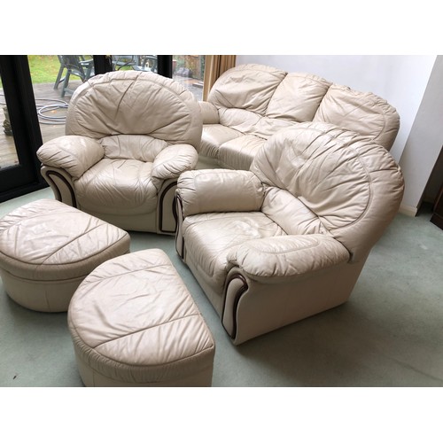 38 - A white leather five piece leather lounge suite, comprising a sofa, two armchairs, and two footstool... 