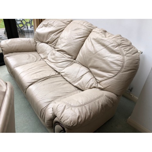 38 - A white leather five piece leather lounge suite, comprising a sofa, two armchairs, and two footstool... 