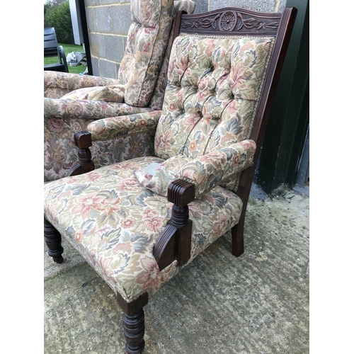 25 - An Edwardian button back armchair together with a modern fireside chair both upholstered in a floral... 