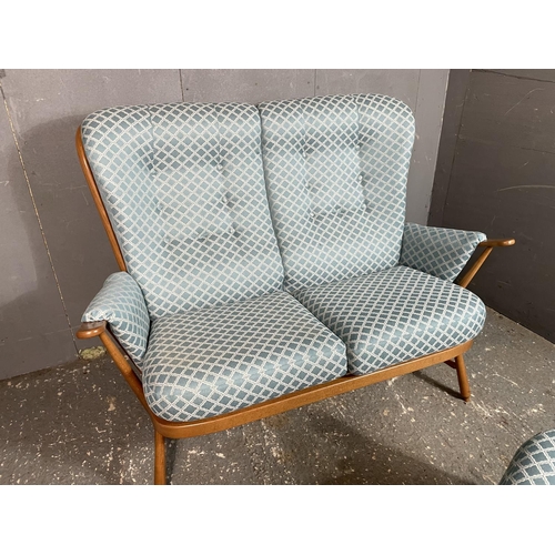 1 - An Ercol four piece stick back lounge suite consisting  of a two seater settee together with two arm... 