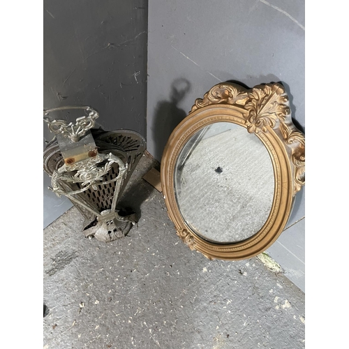 100 - A gold gilt wall mirror together with a brass fire guard