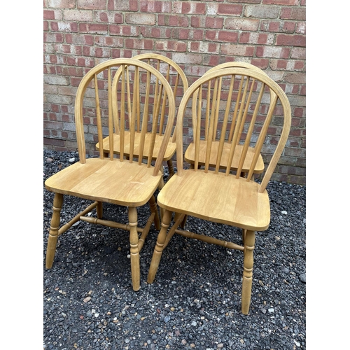 113 - A set of four modern beechwood Stickback chairs