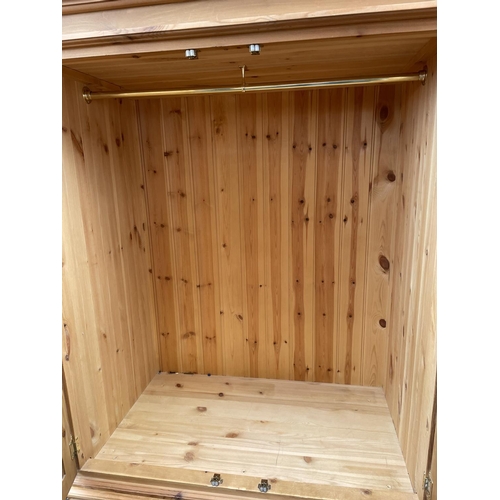 116 - A solid pine combination wardrobe, hanging section over four drawer base 100x60x192