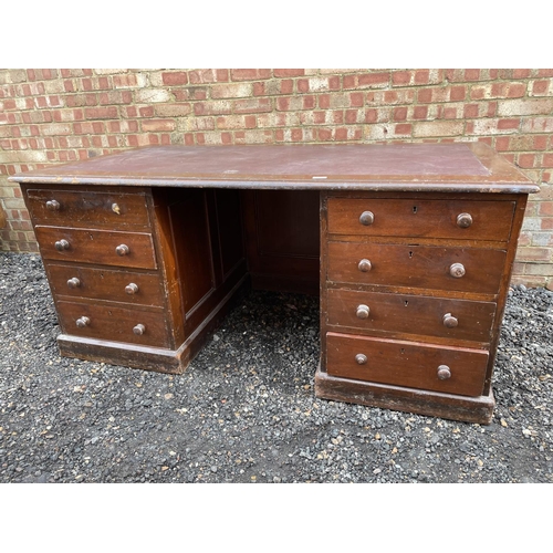 120 - A large twin pedestal mahogany station masters partners desk with a red leather top over two four dr... 