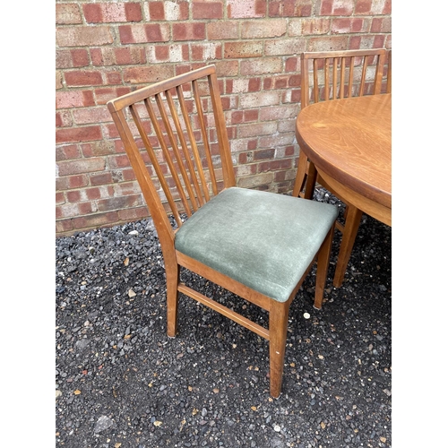 131 - A mid century extending teak dining table together with six chairs