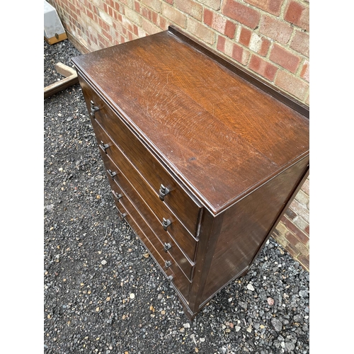 135 - A 20th century oak chest of five drawers