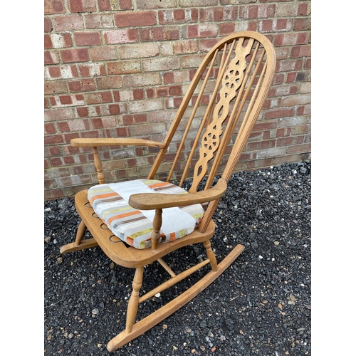 144 - An Elm wheelback rocking chair