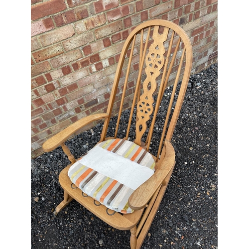 144 - An Elm wheelback rocking chair