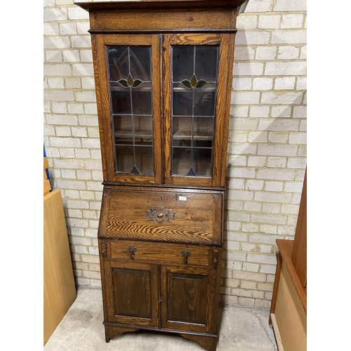 157 - A 1920's oak bureau bookcase with leaded glass top, drop down writing surface and single drawer