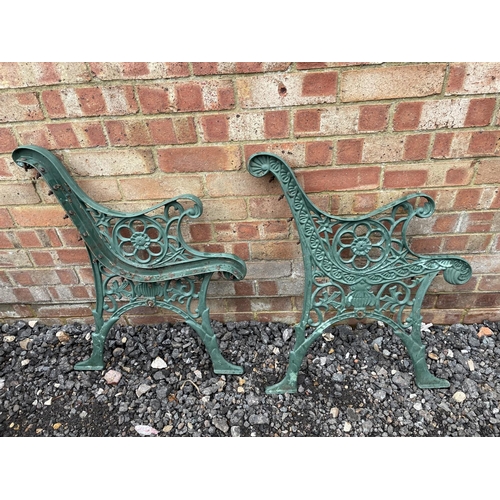 162 - A pair of green iron garden bench ends