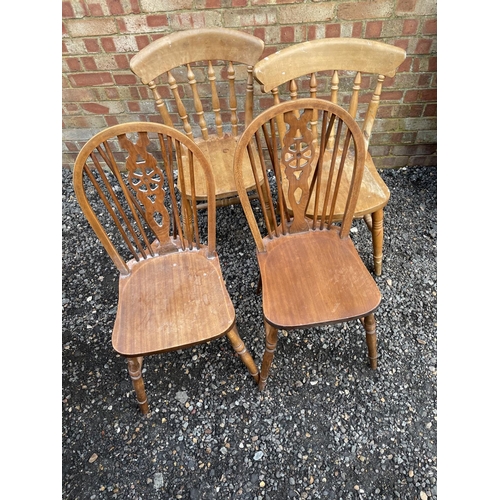 183 - A pair of wheelback chairs together with a a pair of pine Windsor chairs