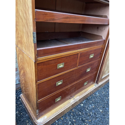 202 - A large Victorian mahogany triple Compactum wardrobe fitted with four slides and four drawers 174x58... 