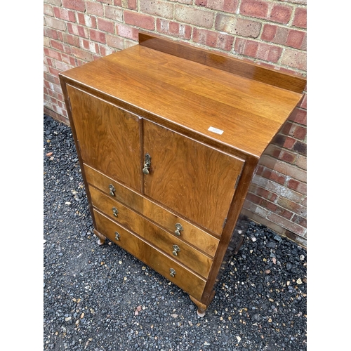 206 - A early 20th century gentlemans wardrobe, cupboard over three drawers