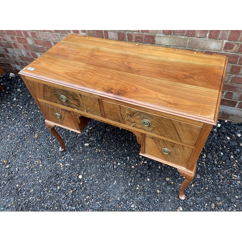 207 - A walnut three drawer writing table