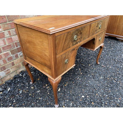 207 - A walnut three drawer writing table