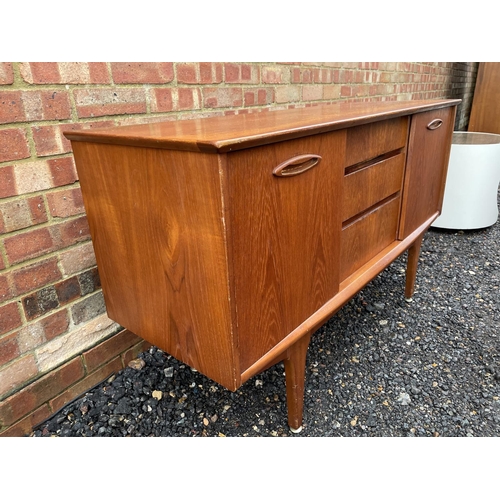 211 - A mid century teak sideboard, three central drawers flanked by two cupboards with sliding doors