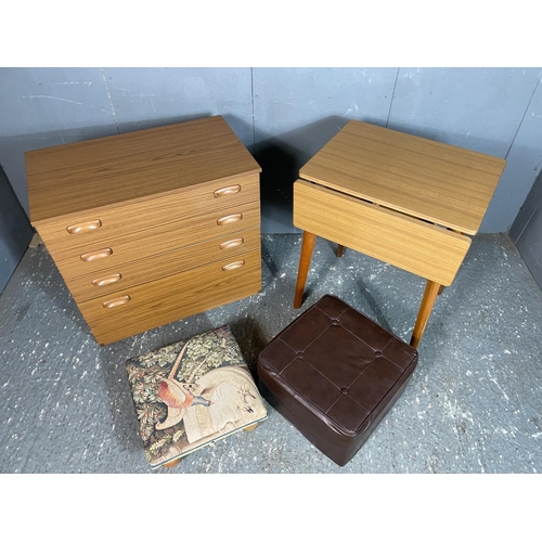 22 - A teak effect chest of four drawers together with a kitchen table and two footstools