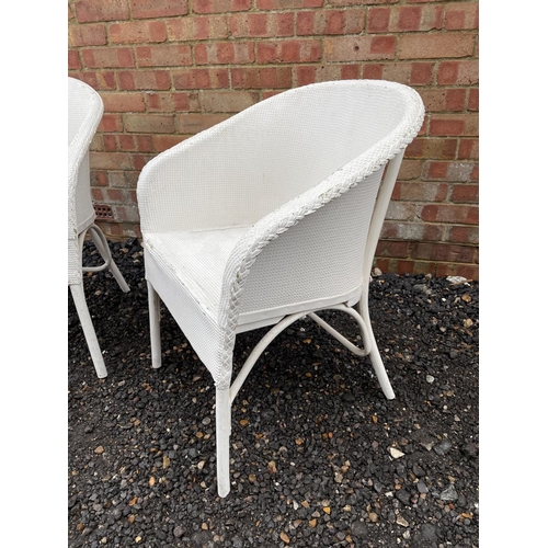 225 - A pair of LLoyd Loom style white painted bedroom chairs