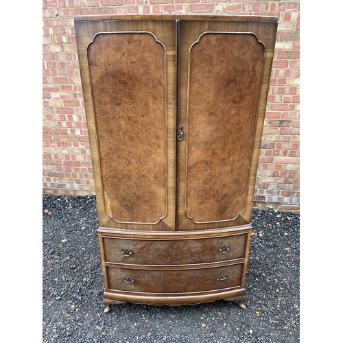 235 - A reproduction walnut gentlemans wardrobe with a fitted interior