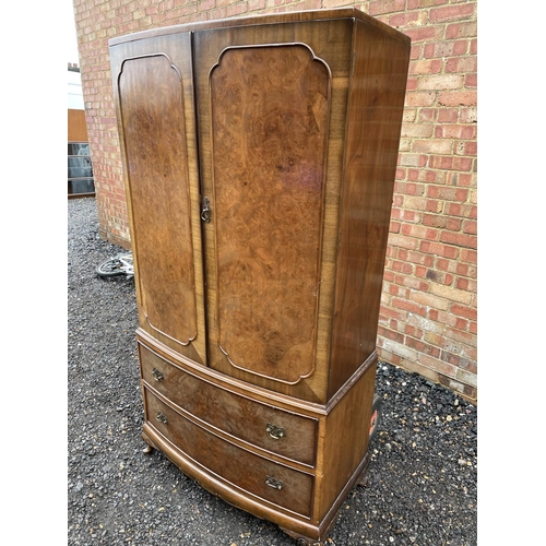 235 - A reproduction walnut gentlemans wardrobe with a fitted interior