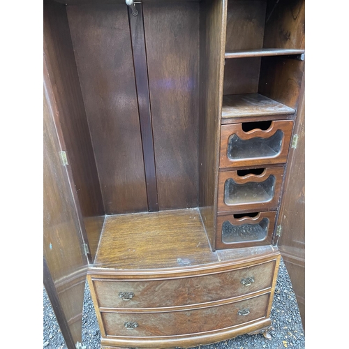 235 - A reproduction walnut gentlemans wardrobe with a fitted interior