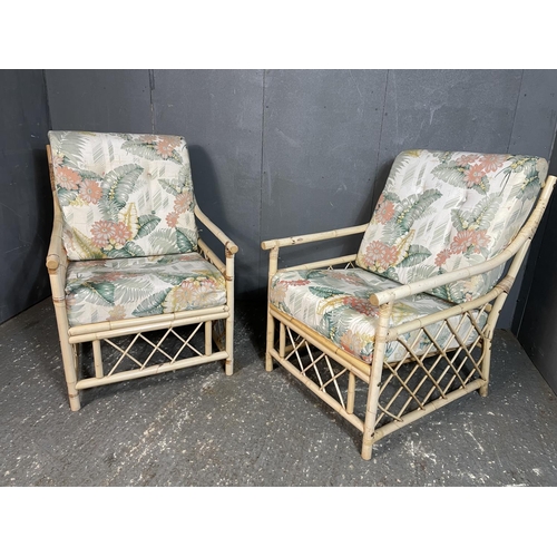 25 - A pair of bamboo armchairs with tropical theme cushion seats