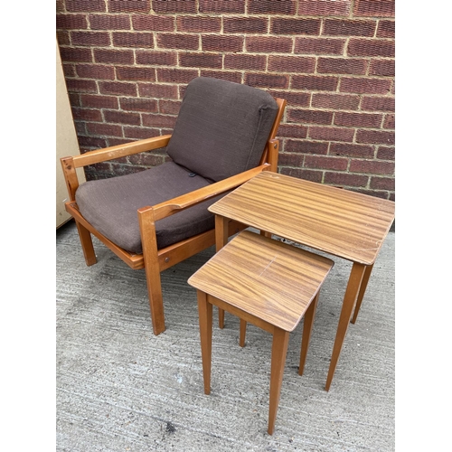 270 - A mid century lounge chair together with a nest of two tables