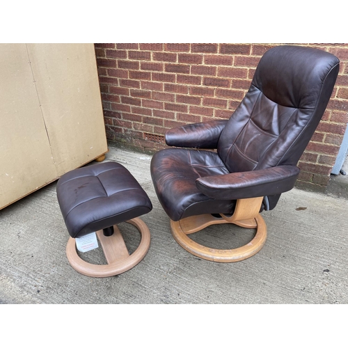 274 - A brown leather reclining easy chair and stool