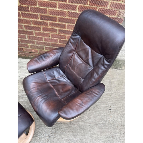 274 - A brown leather reclining easy chair and stool