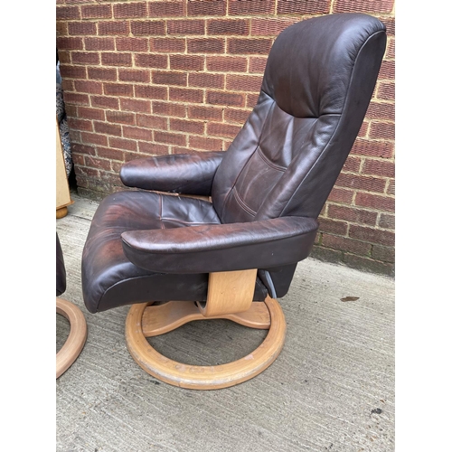 274 - A brown leather reclining easy chair and stool