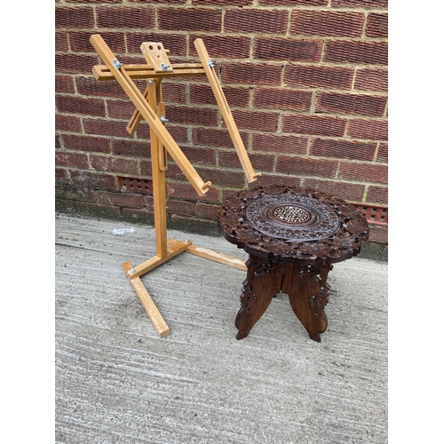 288 - A folding embroidery stand together with an African style table