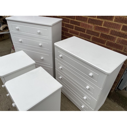 295 - A modern white four piece bedroom suite consisting of two chests and a pair of white bedsides