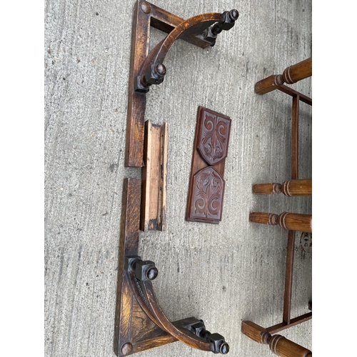 305 - A pair of oak framed dining chairs, together with a mirror, fender and a book rack