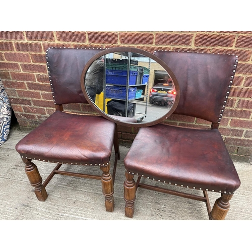 305 - A pair of oak framed dining chairs, together with a mirror, fender and a book rack