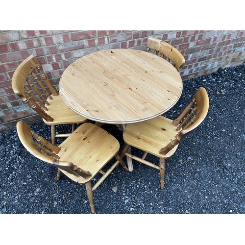 325 - A circular pine kitchen table and four chairs 90cm diameter