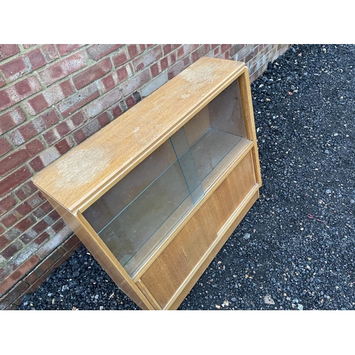 328 - A mid century light oak bookcase cupbaord