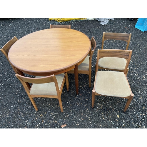 338 - An extending circular g Plan teak table together with a set of 6 mid century chairs